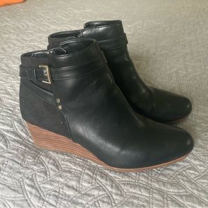 Black ankle boots with zipper and gold accents